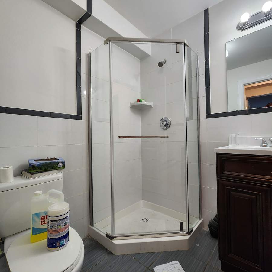 Corner shower with white tile