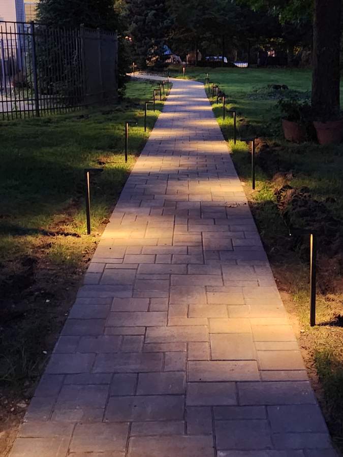 Paver walkway with path lighting at dusk